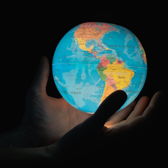 Illuminated globe showing Earth's continents highlighting international customer reach and global communication