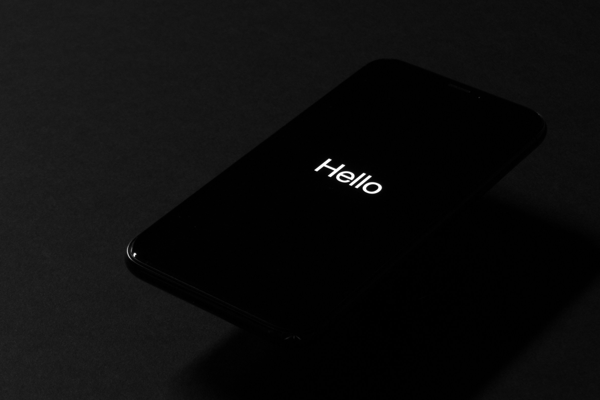 Black laptop displaying 'Hello' greeting screen demonstrating chatbot conversation initiation