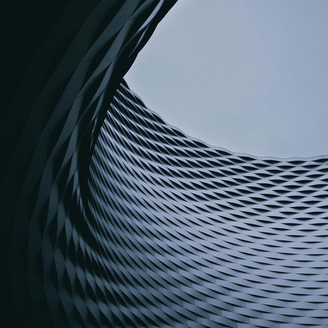 Modern curved glass building facade representing smooth technology integration